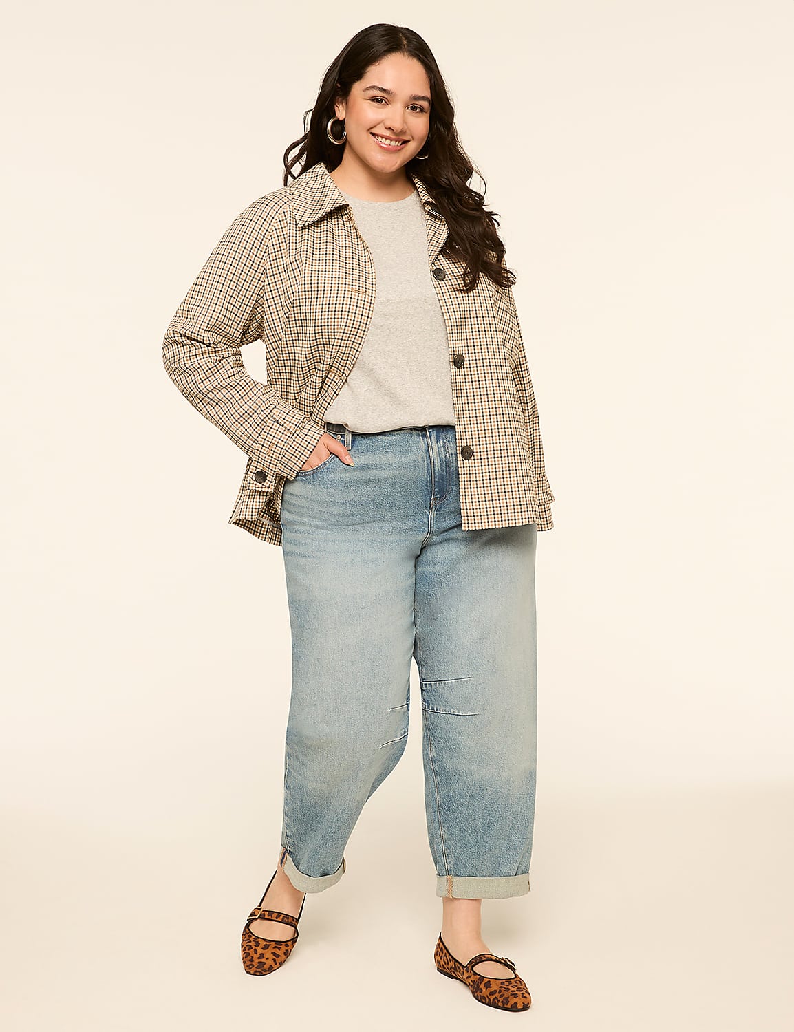 A smiling woman in a plaid jacket and jeans stands against a plain, light-colored background. Product Image 3