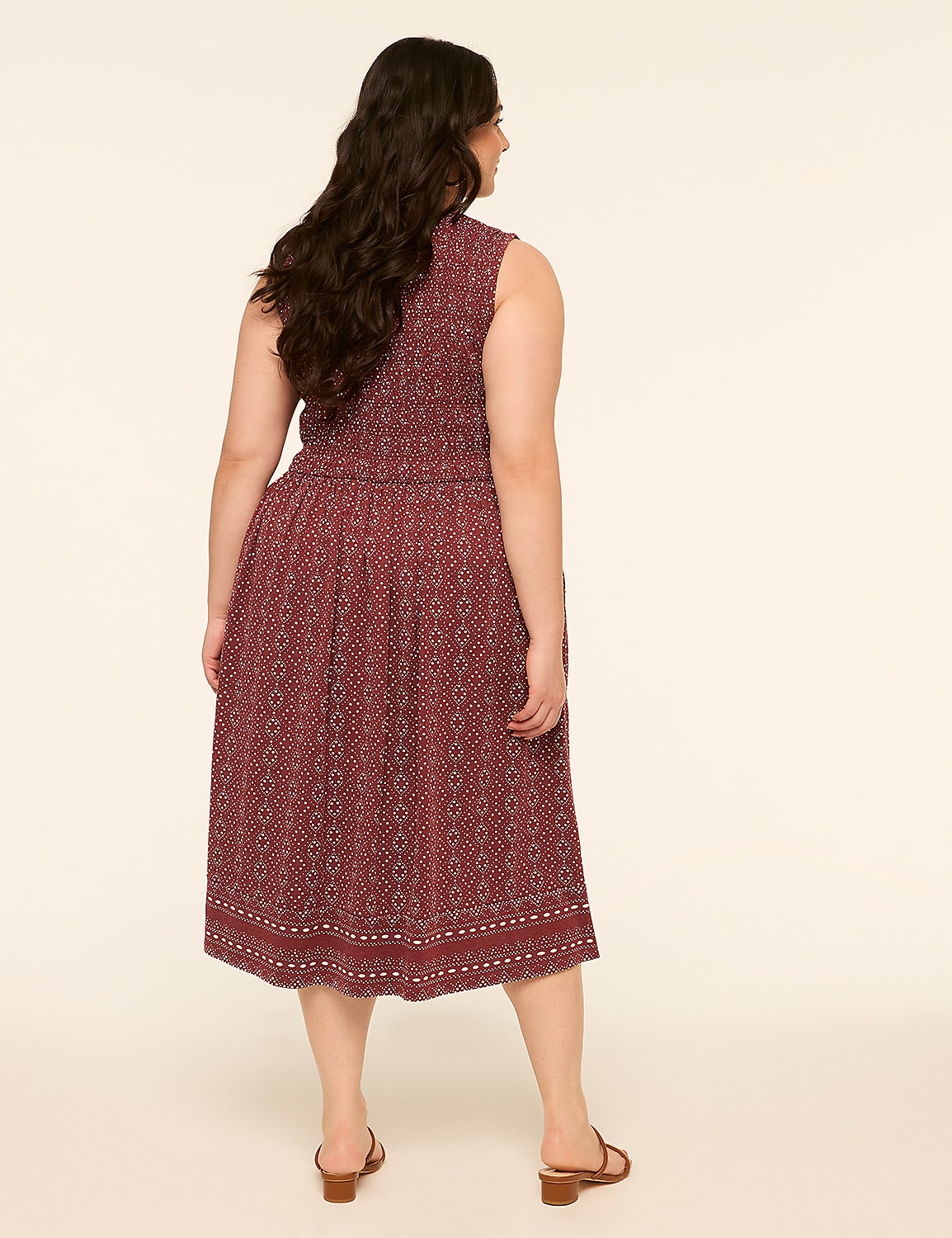 A woman in a patterned dress stands against a plain, light background. Product Image 2