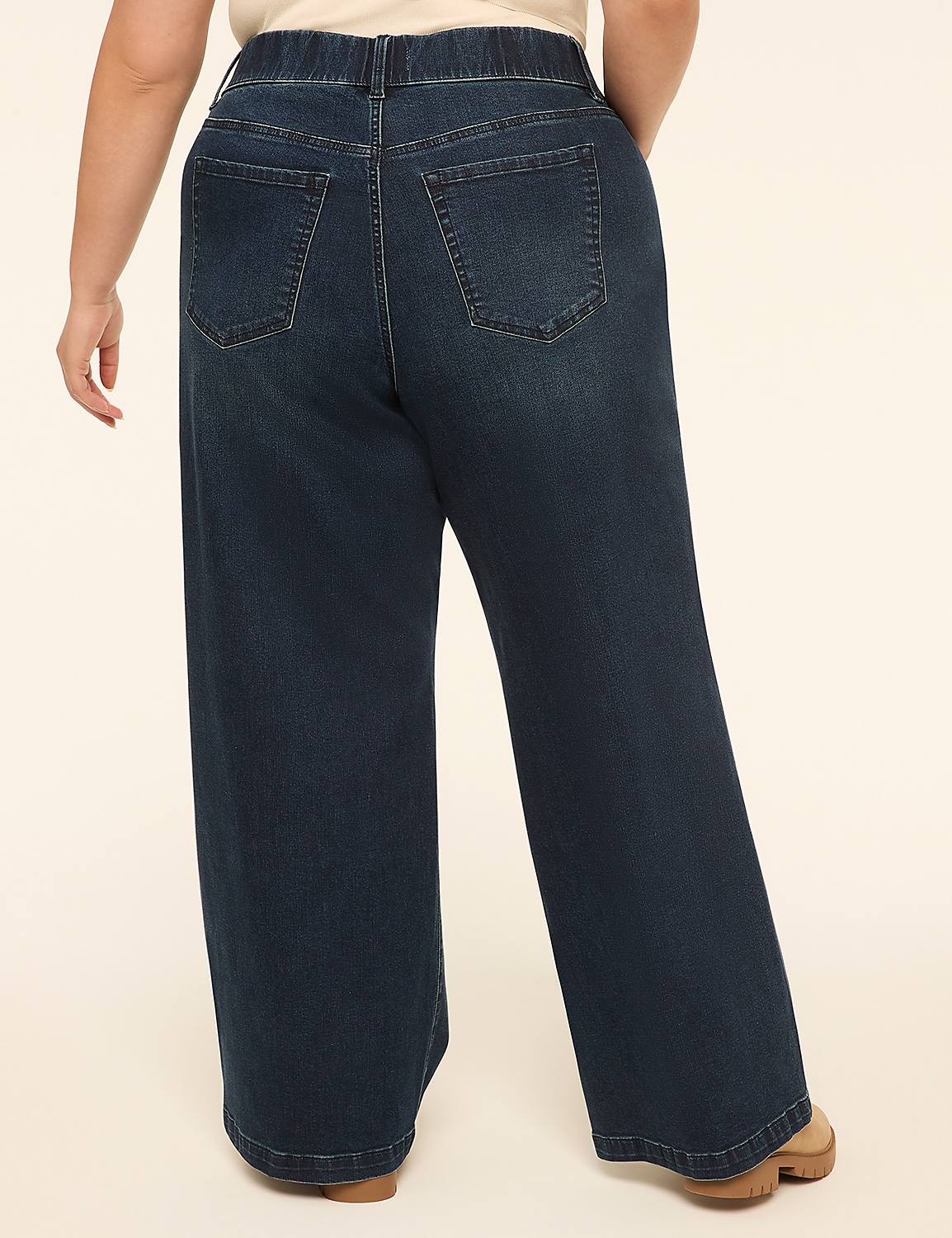 A person wearing dark wash wide-leg jeans stands against a plain, light-colored background. Product Image 2