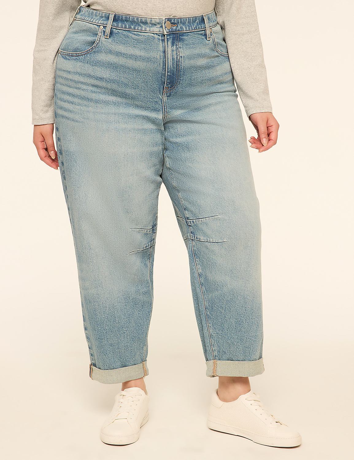 A person in light blue cuffed jeans and white sneakers stands against a plain, light-colored background. Product Image 1