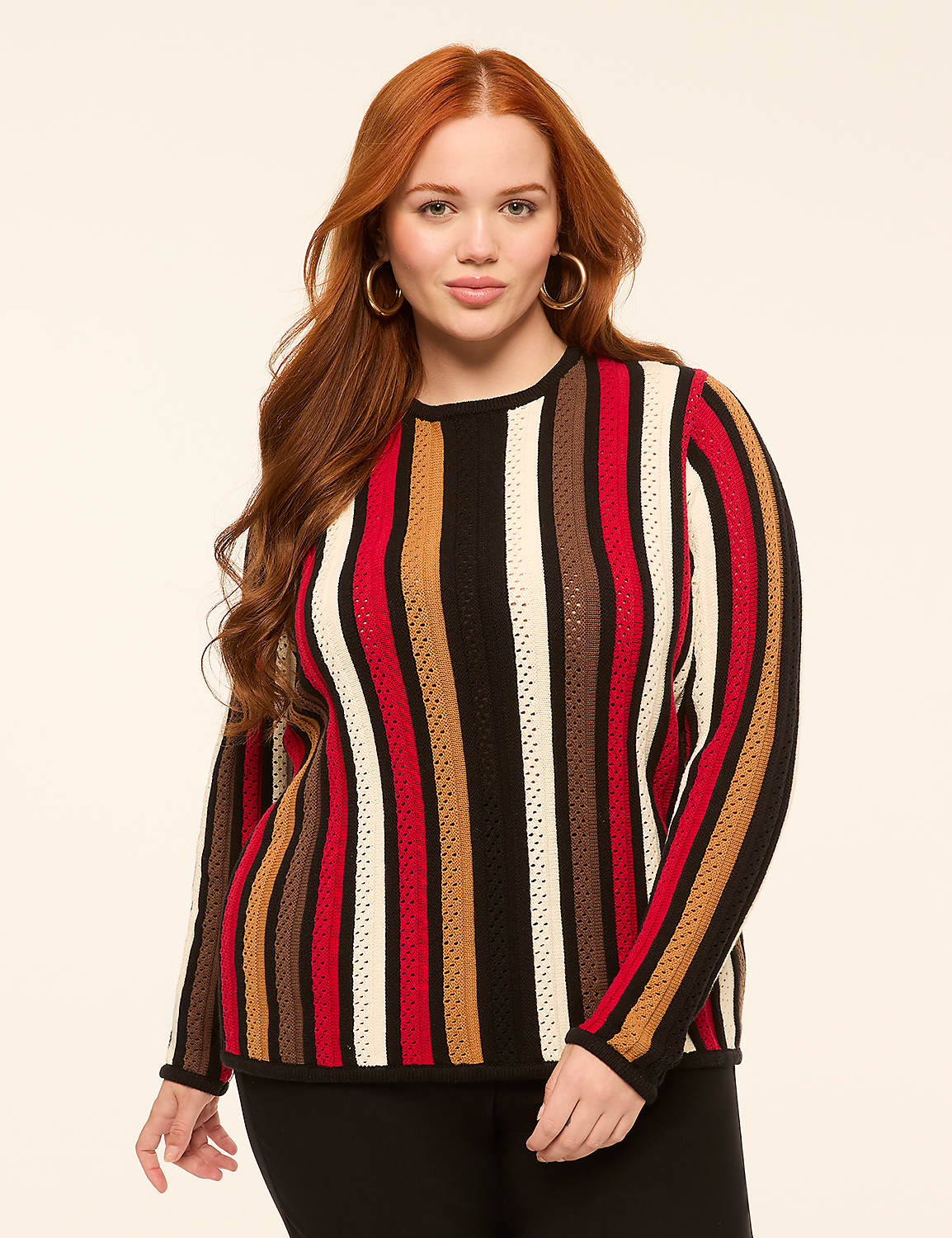A woman with long red hair and a striped sweater stands against a plain, light-colored background. Product Image 1
