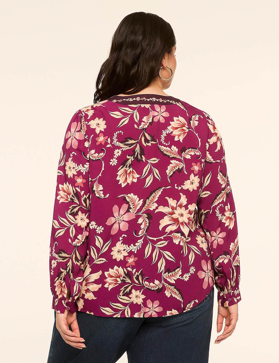 A woman in a floral print blouse stands against a plain, light-colored background. Product Image 2