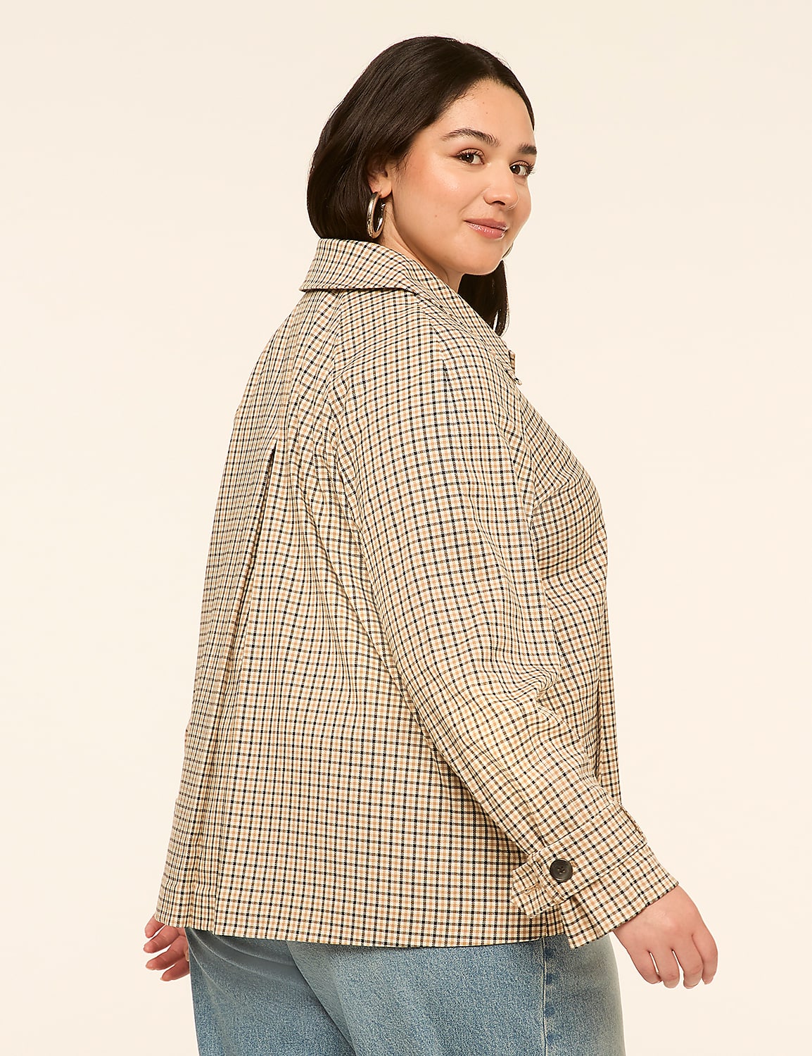 A woman in a checkered jacket and jeans stands against a plain, light-colored background. Product Image 2
