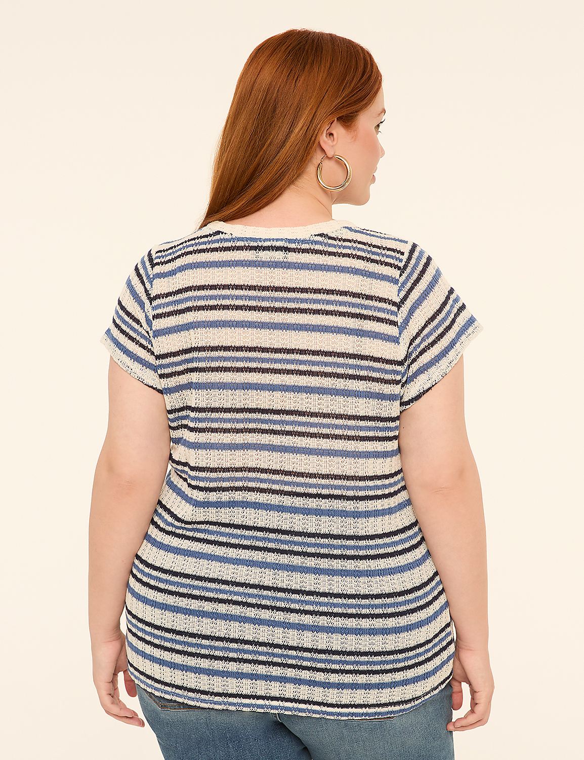 A woman with red hair, wearing a striped shirt and jeans, stands against a plain, light-colored background. Product Image 2