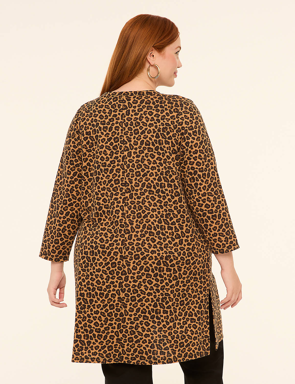 A woman with red hair wearing a leopard print tunic stands against a plain, light-colored background. Product Image 2