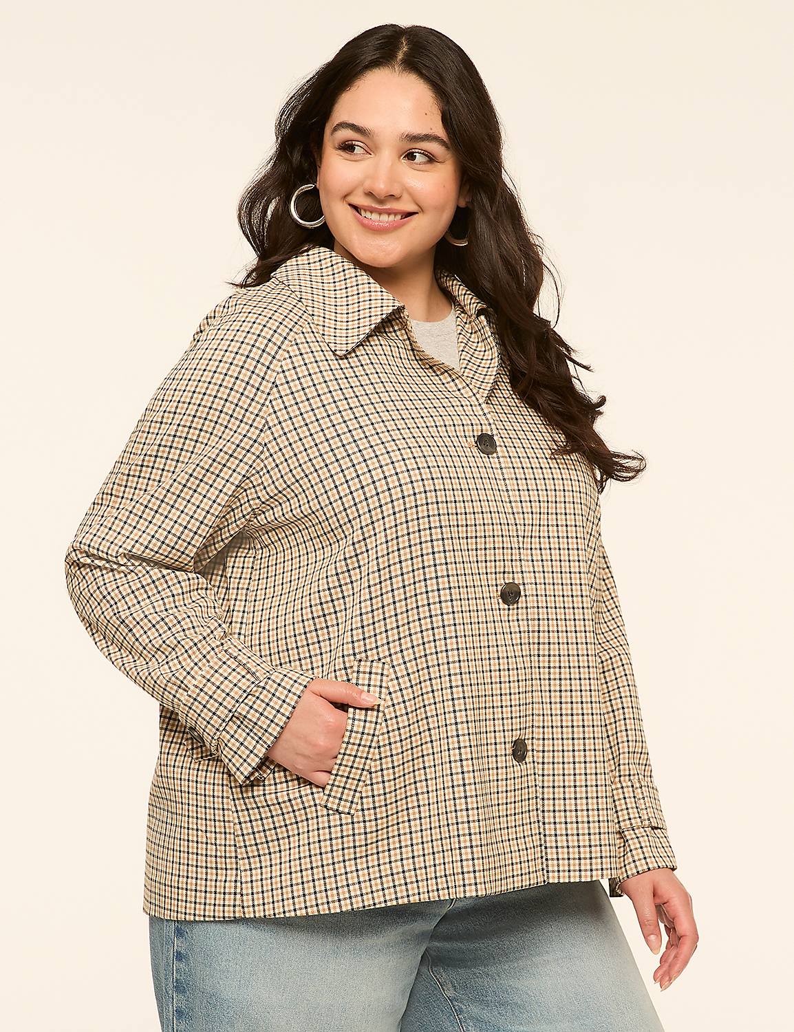 A woman in a checkered jacket and jeans stands against a plain, light-colored background. Product Image 1