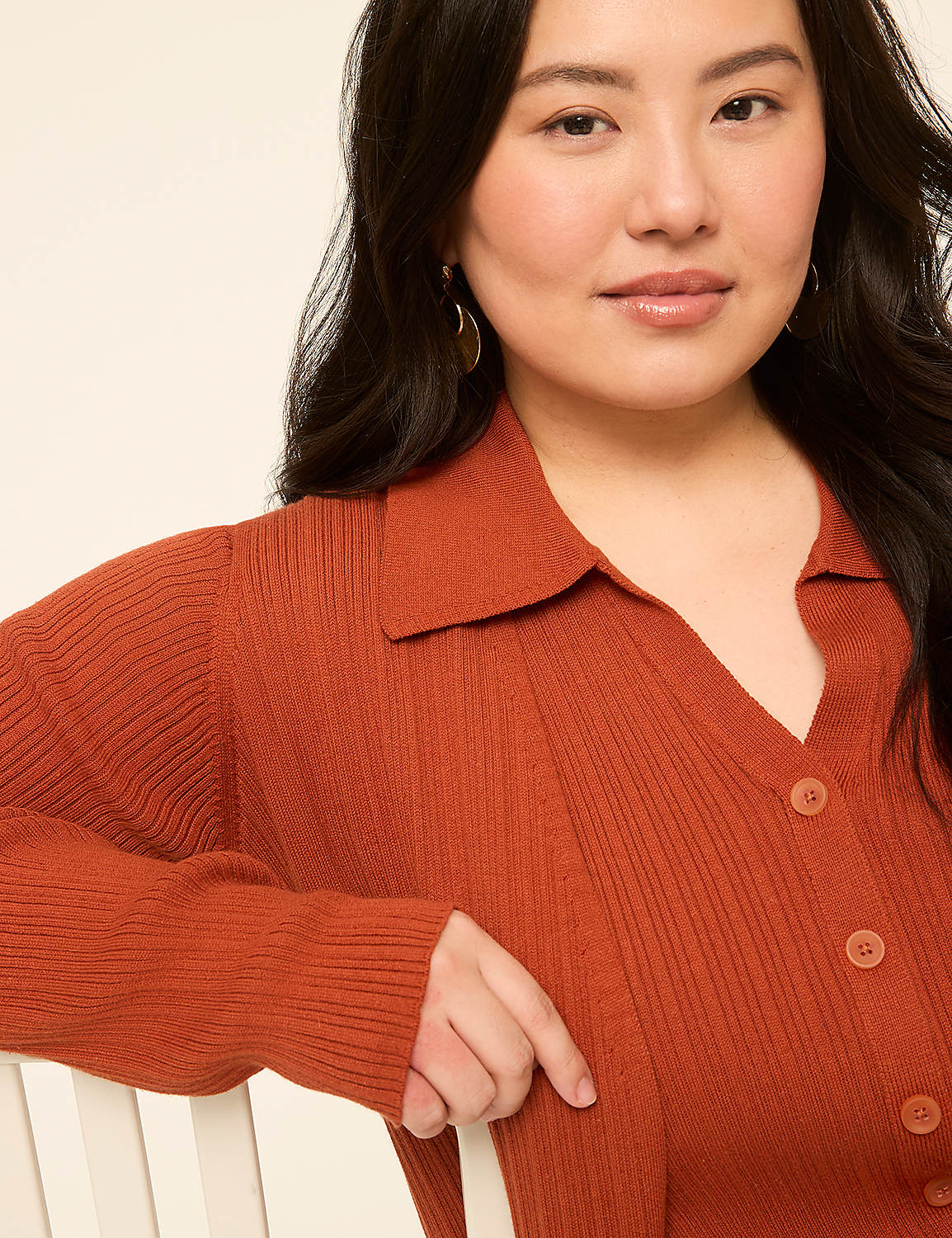 A woman in a rust-colored ribbed cardigan with a collared neckline poses against a plain, light-colored background. Product Image 3