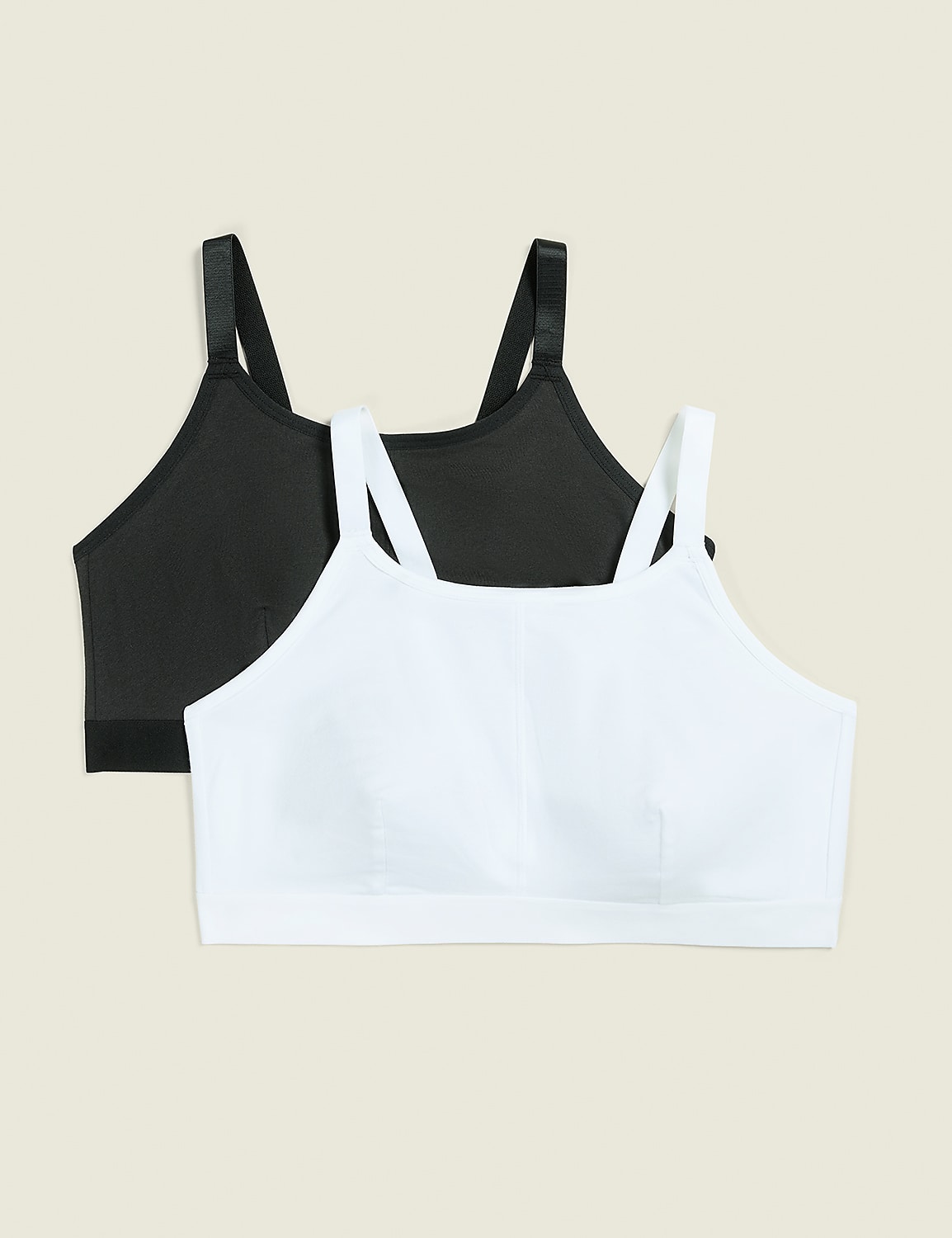 Two sports bras, one white in the foreground and one black in the background, are displayed against a plain, light beige backdrop. Product Image 1