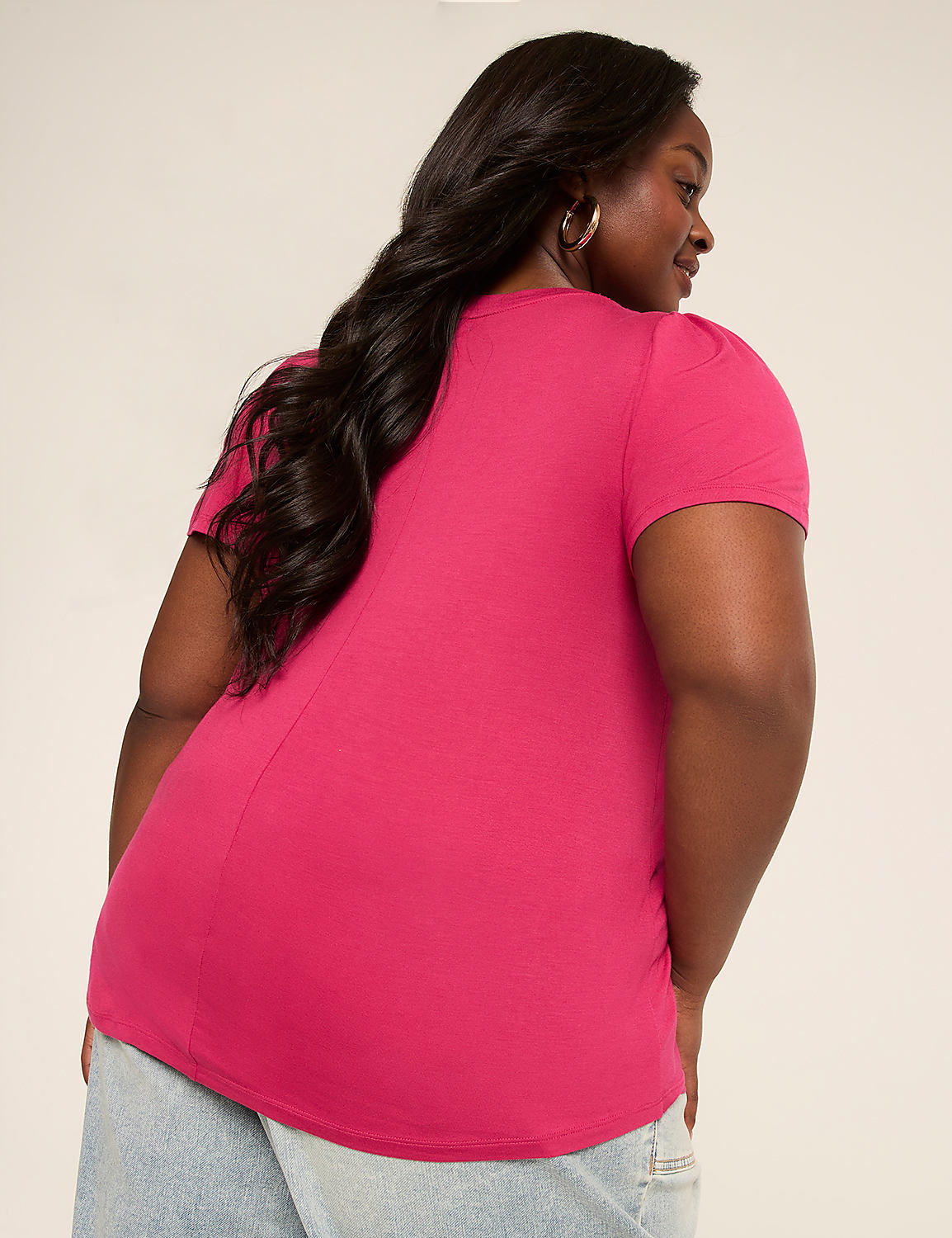 A woman in a bright pink t-shirt and jeans stands against a plain, light-colored background. Product Image 2