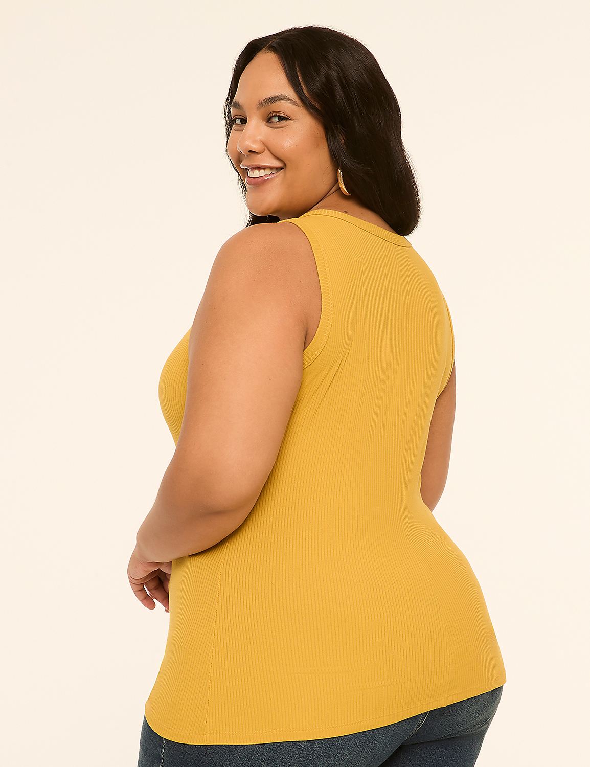 A smiling woman in a mustard yellow ribbed tank top poses against a plain, light-colored background. Product Image 2