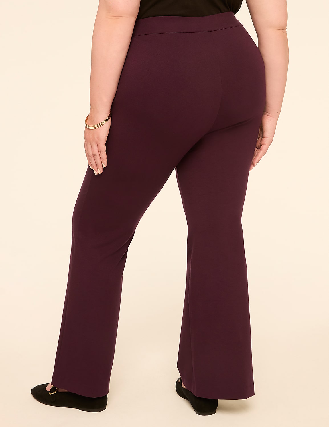 A person wearing plum-colored flared pants and black flats stands against a plain, light-colored background. Product Image 2
