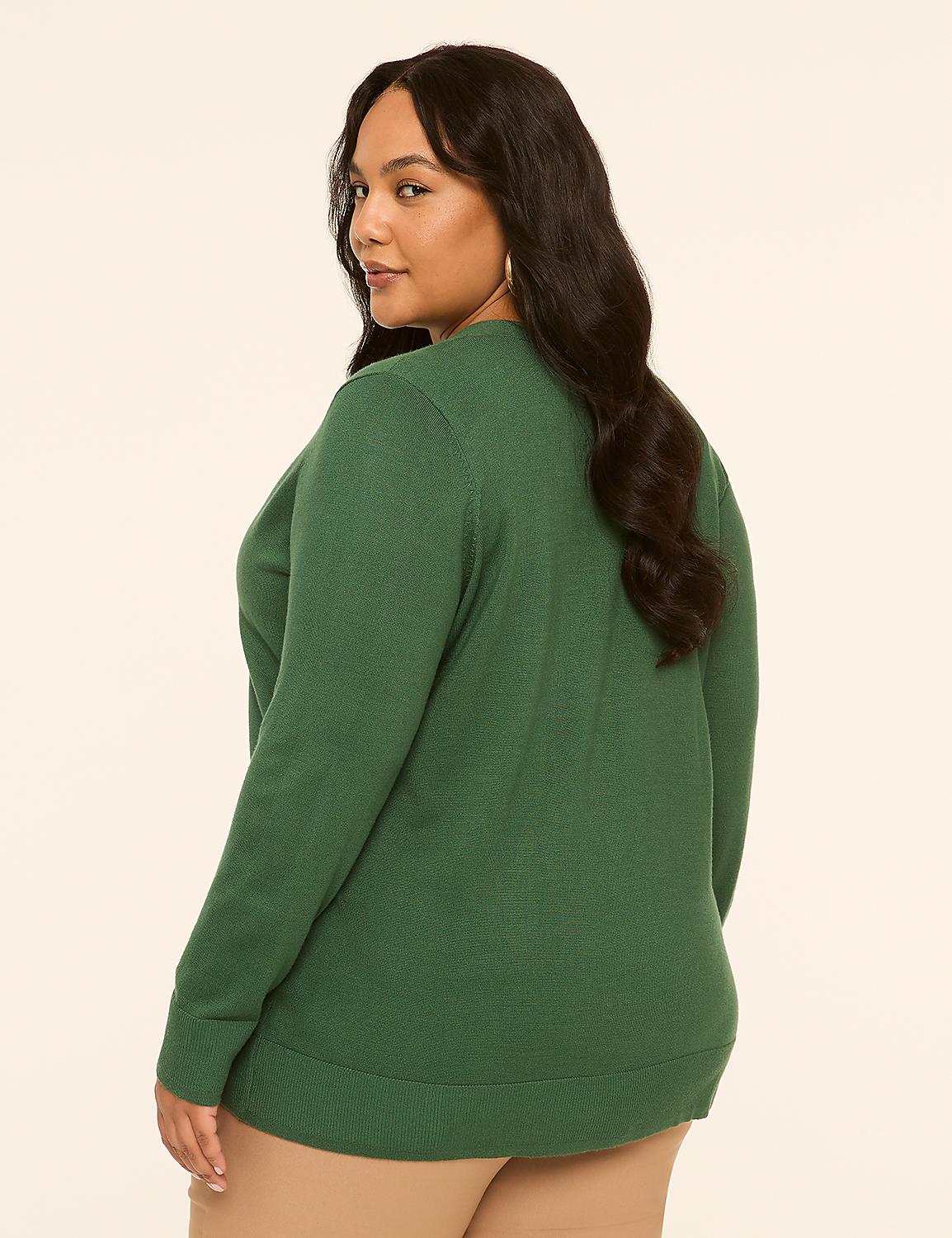A woman in a green sweater stands against a plain, light-colored background. Product Image 2