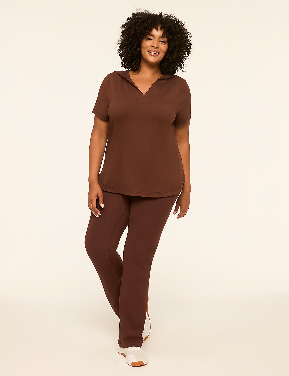 A woman in a brown hooded shirt and pants stands against a plain, light-colored background. Product Image 3