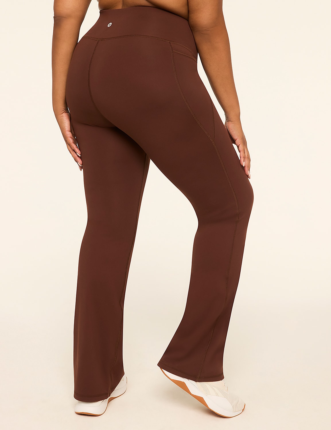 A person wearing brown flared yoga pants stands against a plain cream background. Product Image 2
