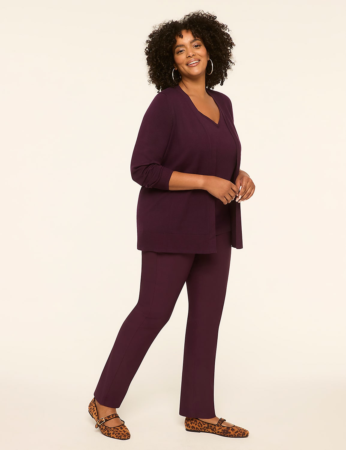 A woman in a plum-colored outfit and leopard print flats stands against a plain, light background. Product Image 3