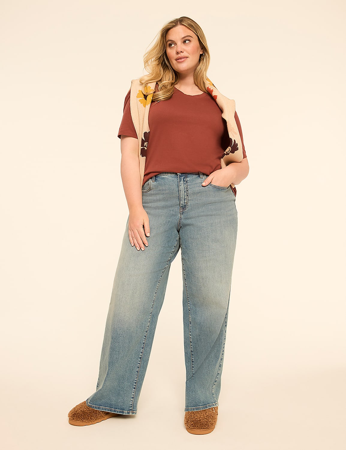 A woman in a rust-colored t-shirt and wide-leg jeans stands against a plain, light-colored background. Product Image 3