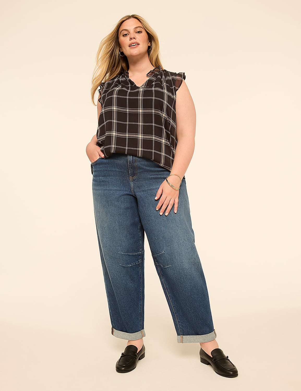 A woman in a plaid top and cuffed jeans stands against a plain, light-colored background. Product Image 4