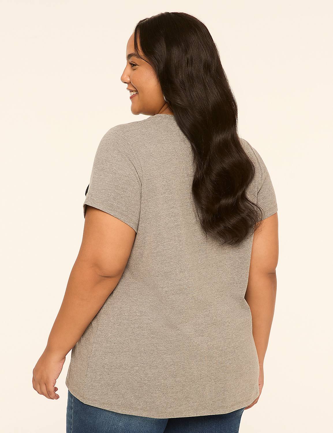 A woman in a grey t-shirt and blue jeans stands against a plain, light-colored background. Product Image 2