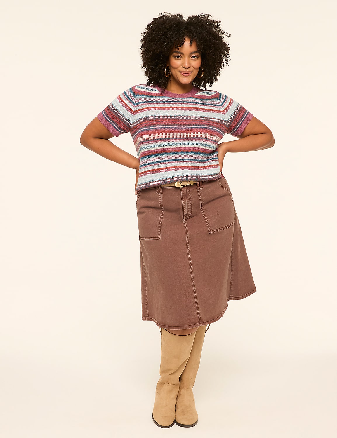 A woman in a striped sweater and brown skirt stands against a plain, light-colored background. Product Image 3