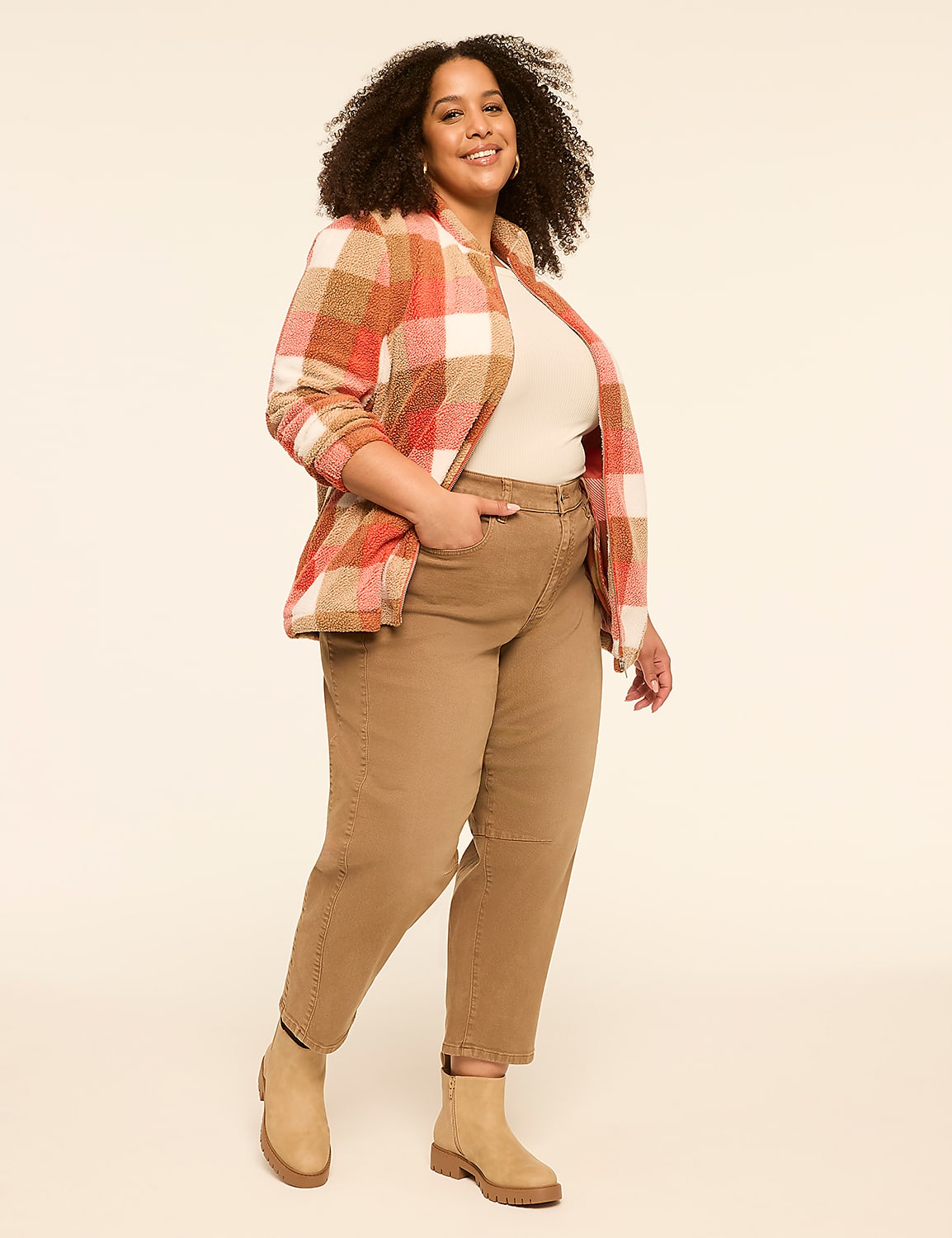 A woman in a plaid jacket and tan pants stands against a plain, light-colored background. Product Image 3