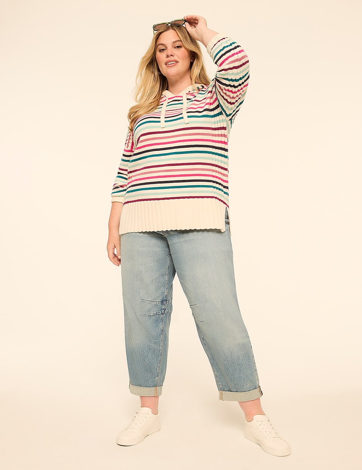 A woman in a striped sweater and jeans stands against a plain, light-colored background. Product Image 3