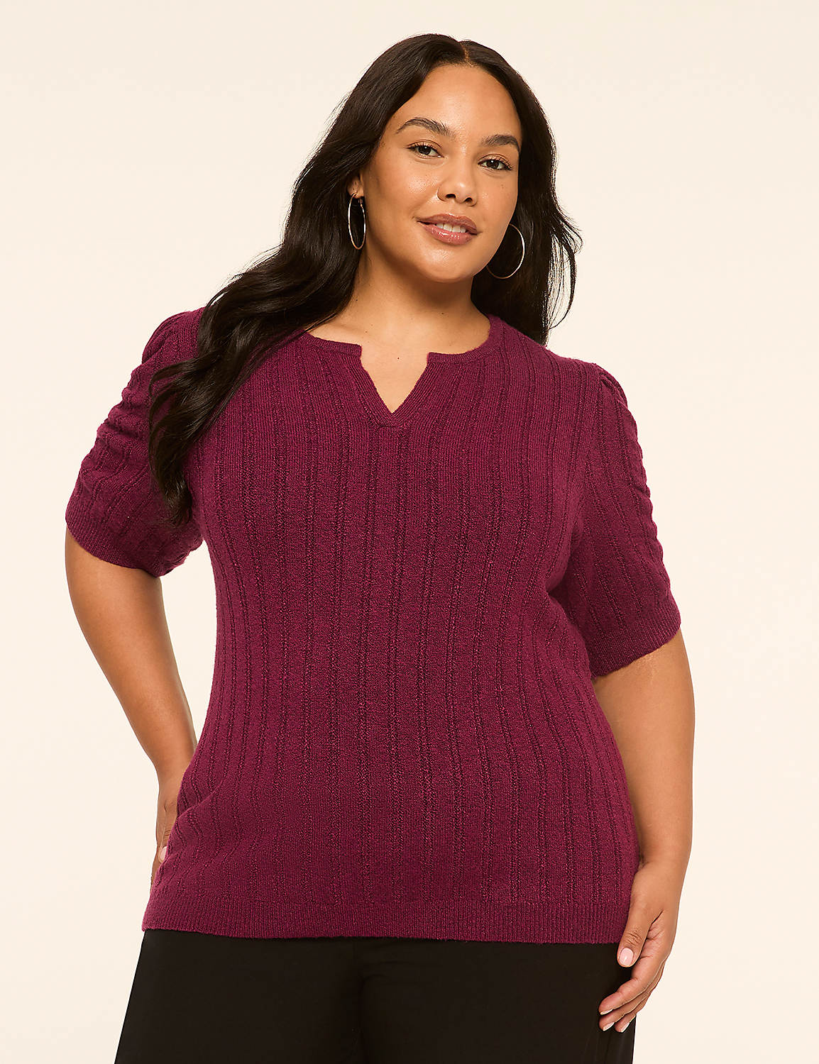 A woman in a plum-colored sweater stands against a plain, light-colored background. Product Image 1