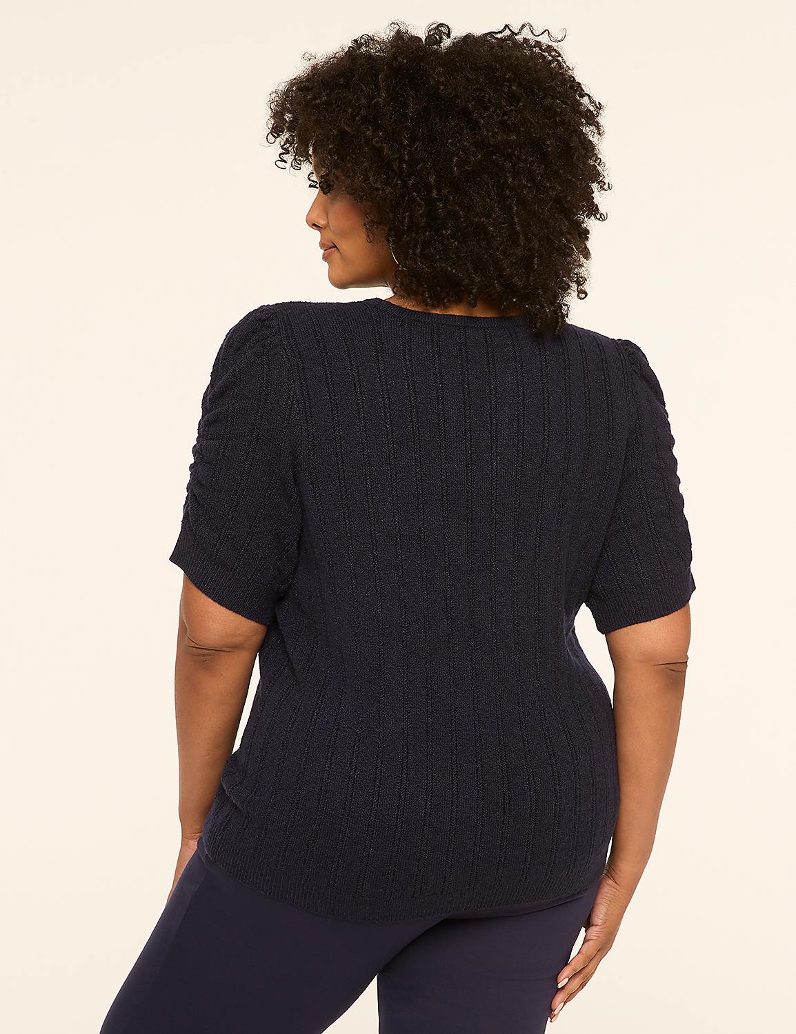 A woman in a navy blue sweater and pants stands against a plain, light-colored background. Product Image 2