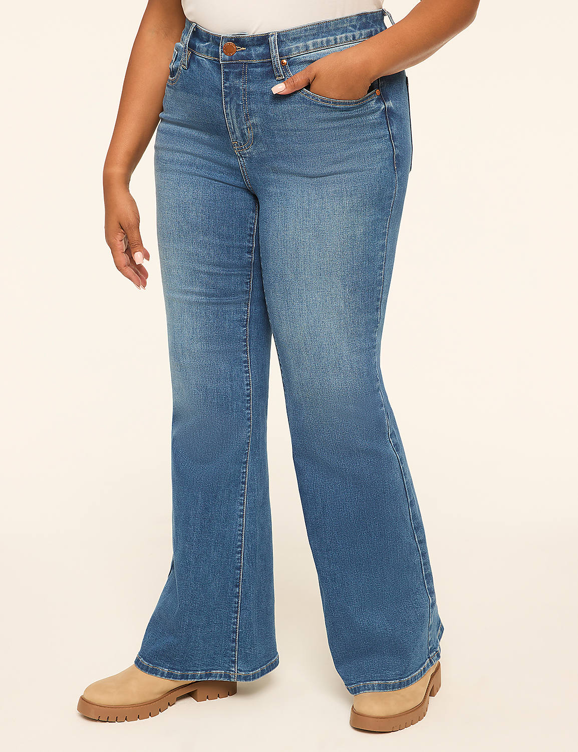 A person in flared blue jeans and tan boots stands against a plain, light-colored background. Product Image 1