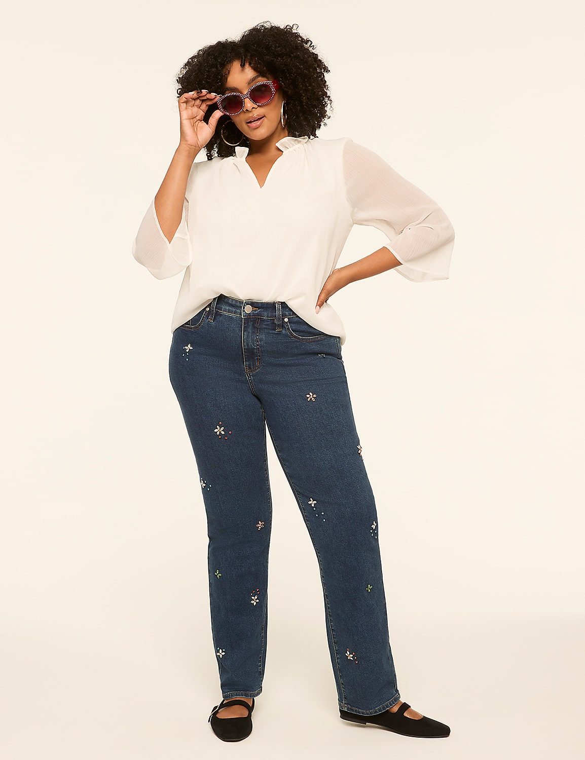 A woman in a white blouse and star-embroidered jeans poses against a plain, light-colored background. Product Image 3