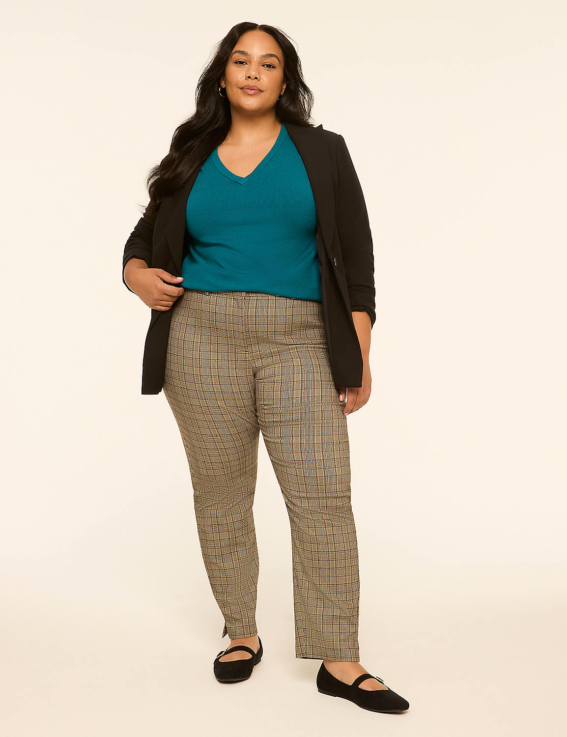 A woman in a teal v-neck shirt, black blazer, and plaid pants stands against a plain, light-colored background. Product Image 3