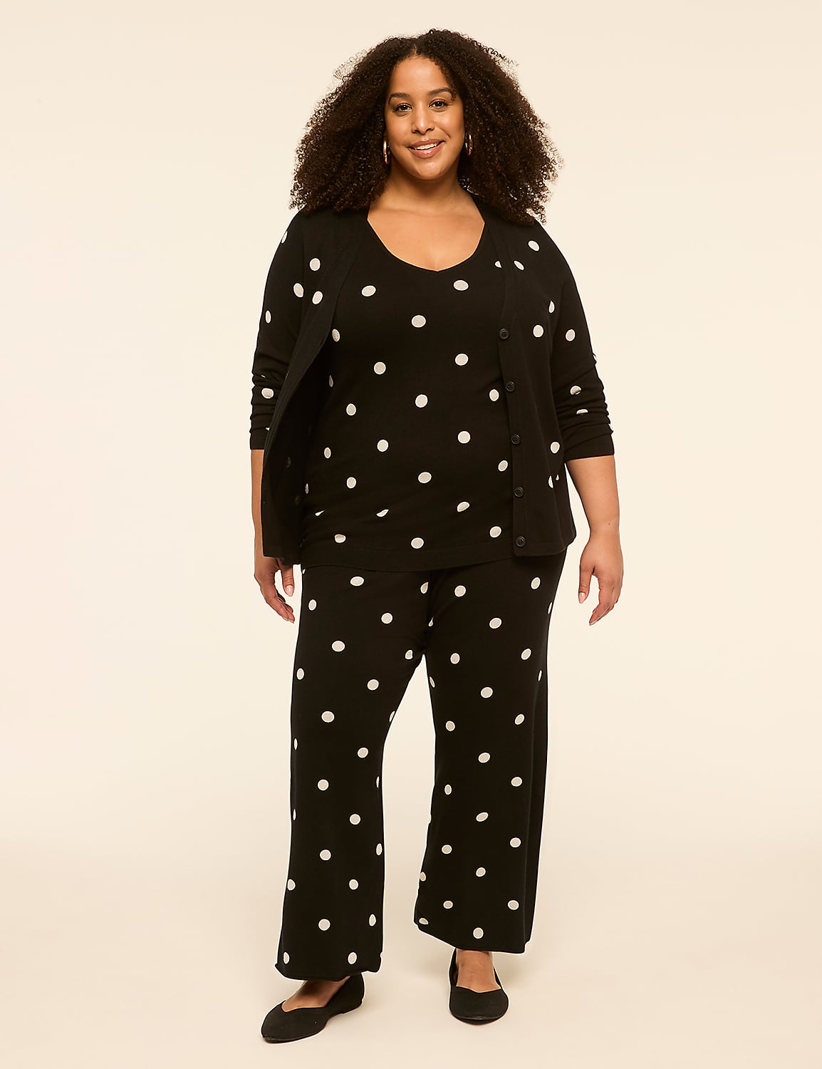 A woman in a black polka dot pajama set stands against a plain, light-colored background. Product Image 3