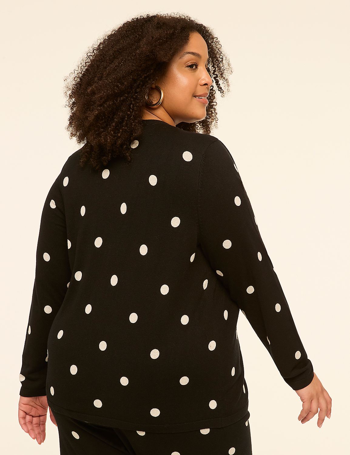 A woman with curly hair wearing a black polka dot sweater is shown from the back against a plain, light-colored background. Product Image 2