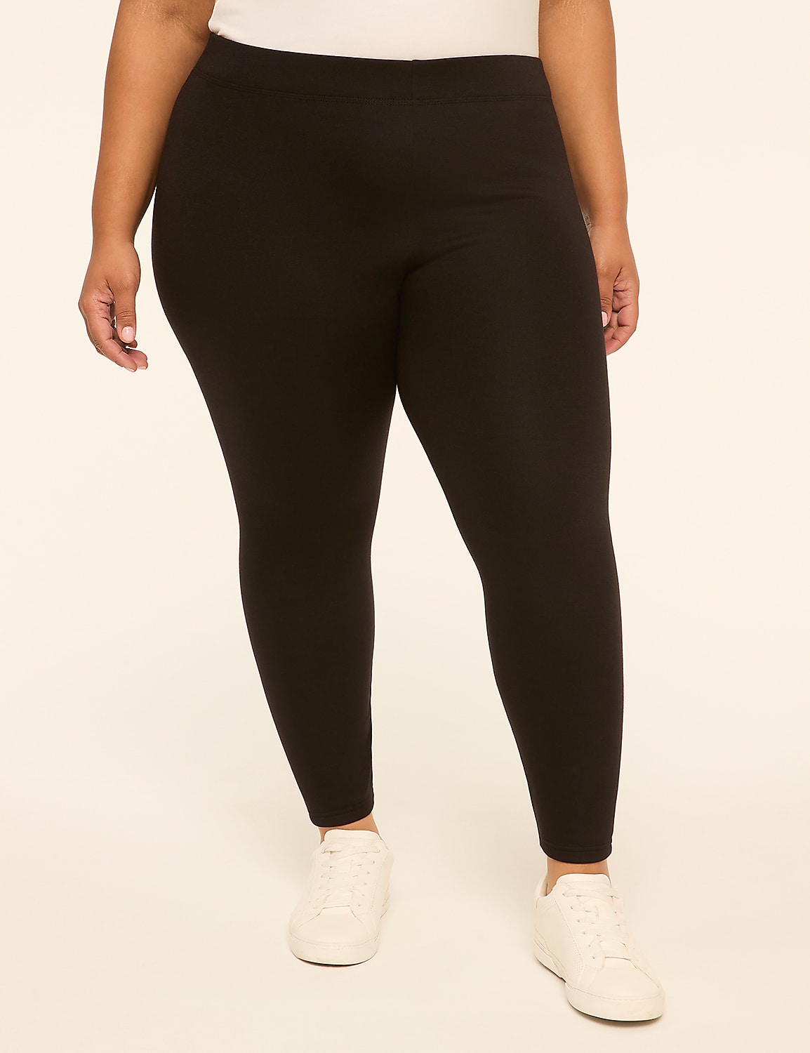 A person wearing black leggings and white sneakers stands against a plain, light-colored background. Product Image 1