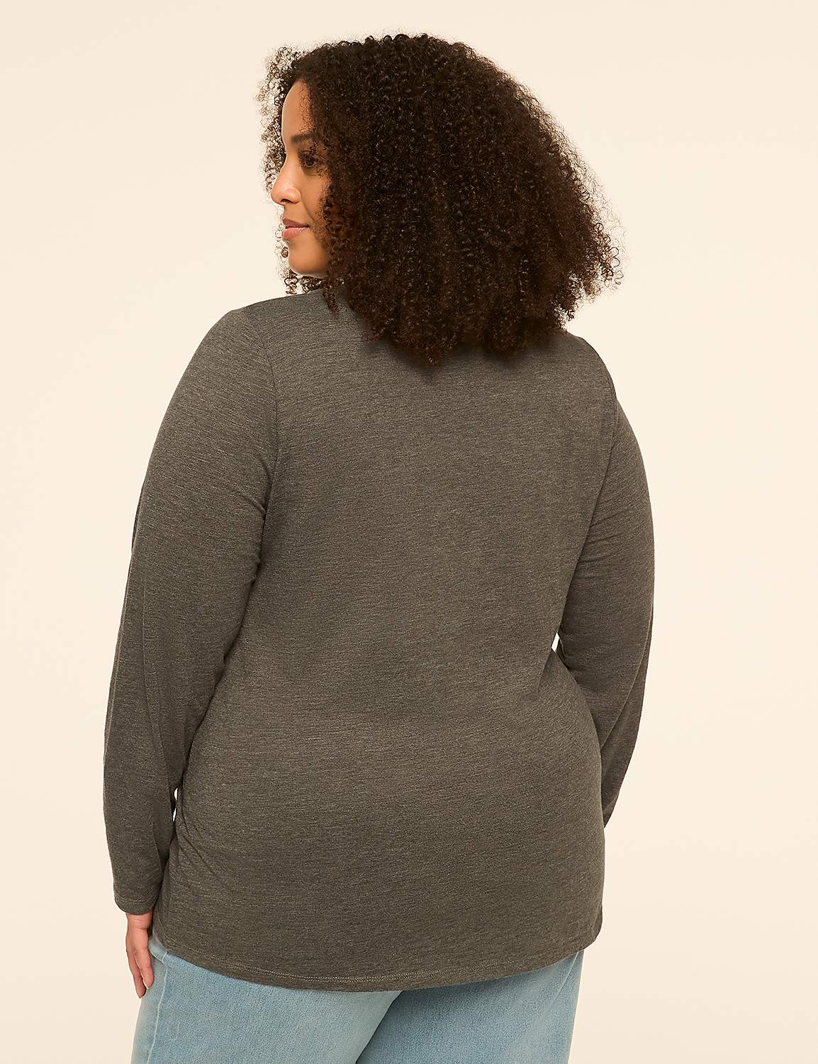 A woman with curly hair, seen from the back, wears a dark gray long-sleeved shirt and light blue jeans against a plain, light-colored background. Product Image 2