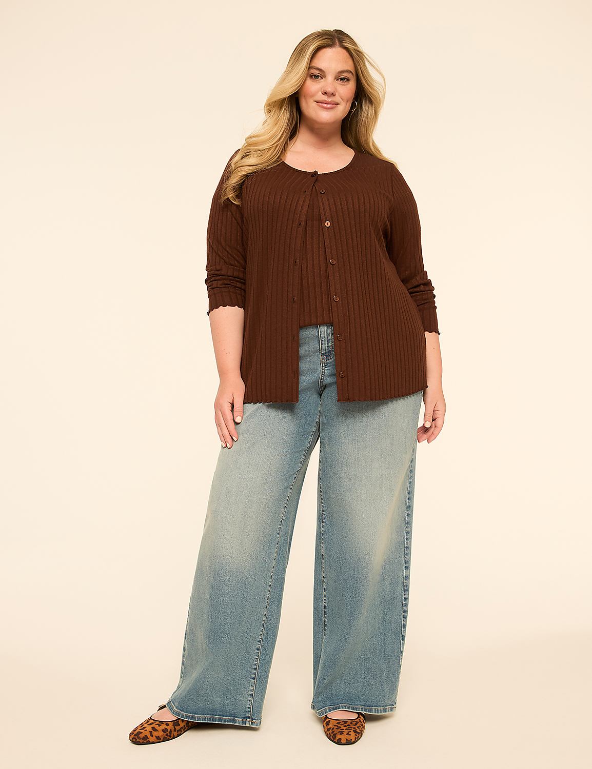 A woman in a brown cardigan and wide-leg jeans stands against a plain, light-colored background. Product Image 3