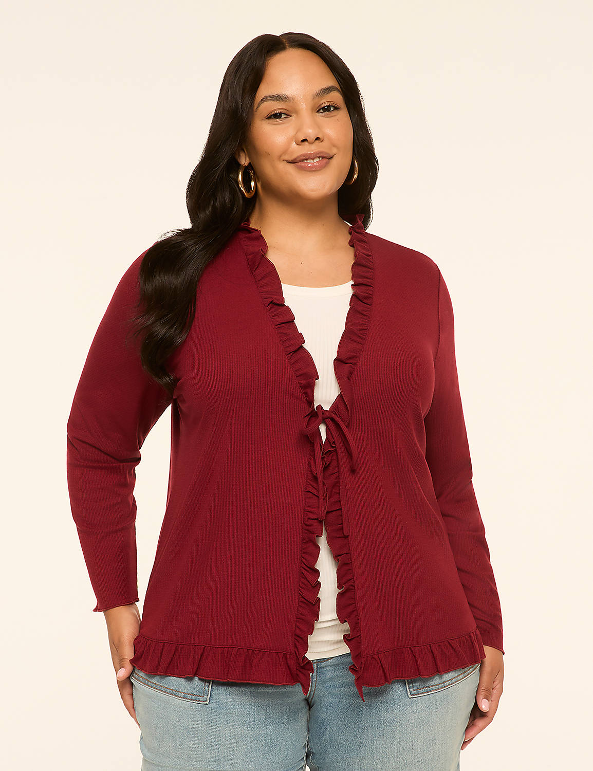 A woman in a maroon ruffled cardigan stands against a plain, light-colored background. Product Image 1