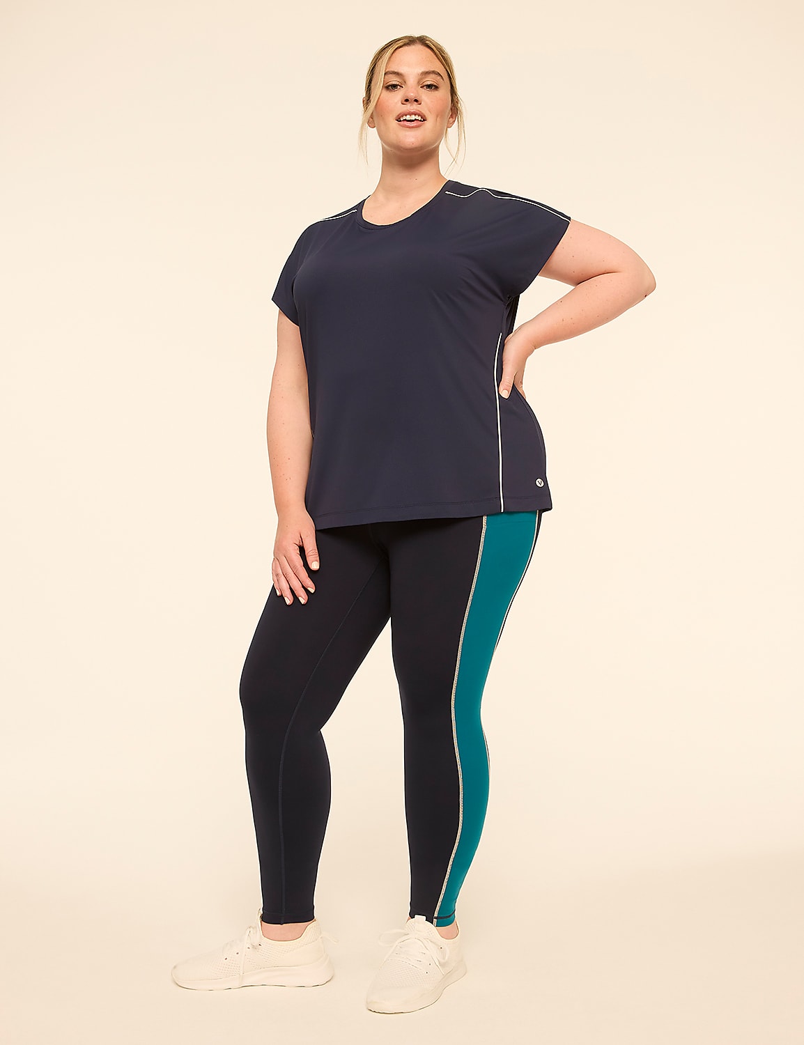 A woman in athletic wear stands against a plain, light-colored background. Product Image 3