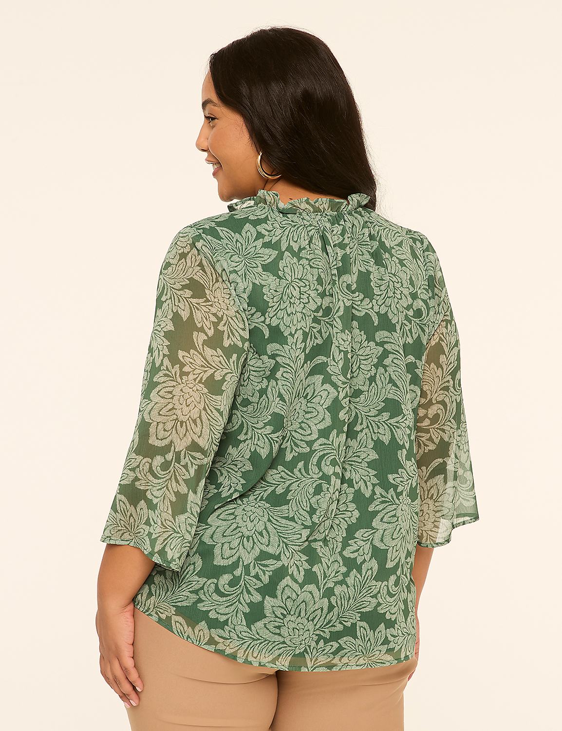 A woman in a green floral blouse stands against a plain, light-colored background. Product Image 2