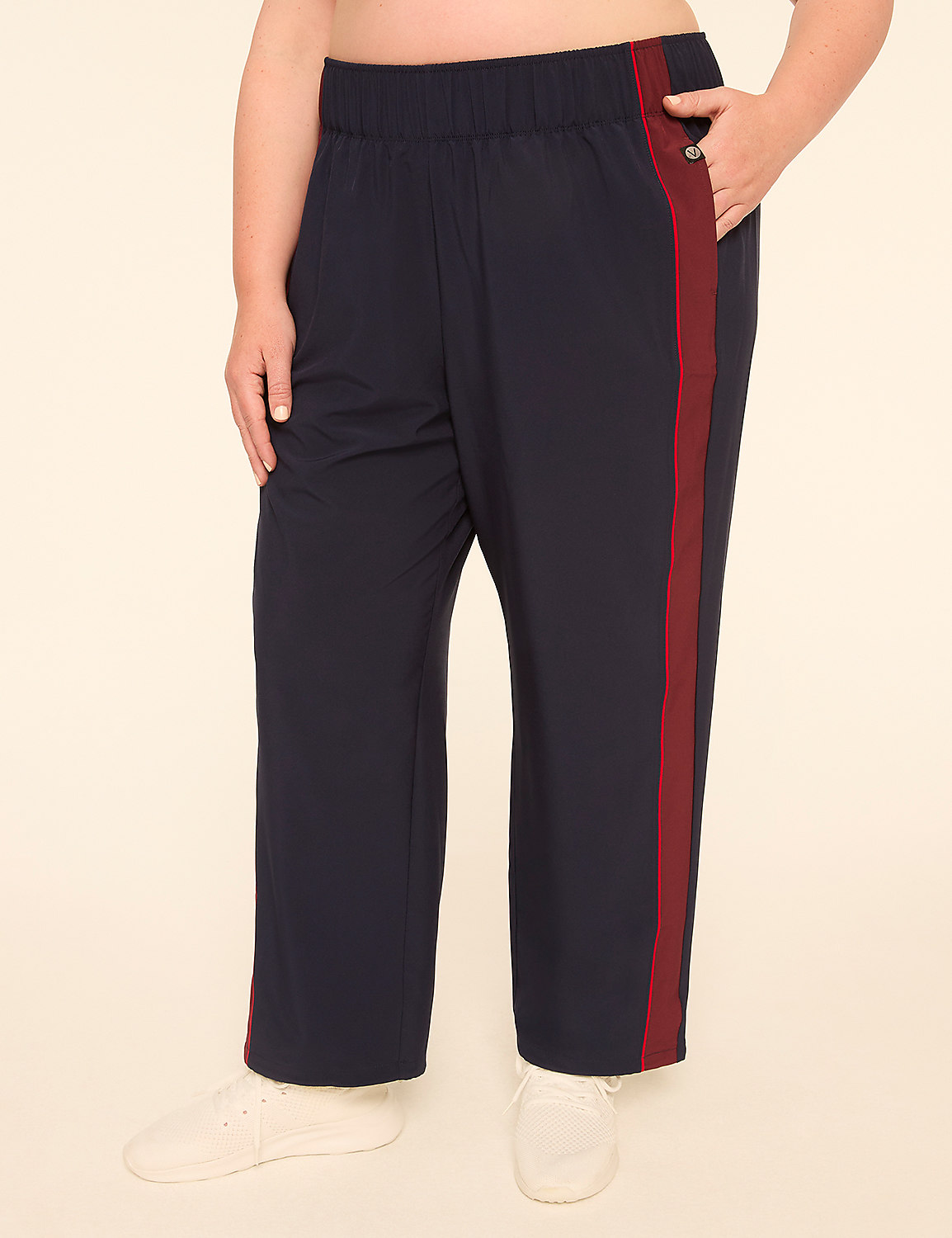 A person wearing navy blue track pants with a maroon stripe stands against a plain, light-colored background. Product Image 1