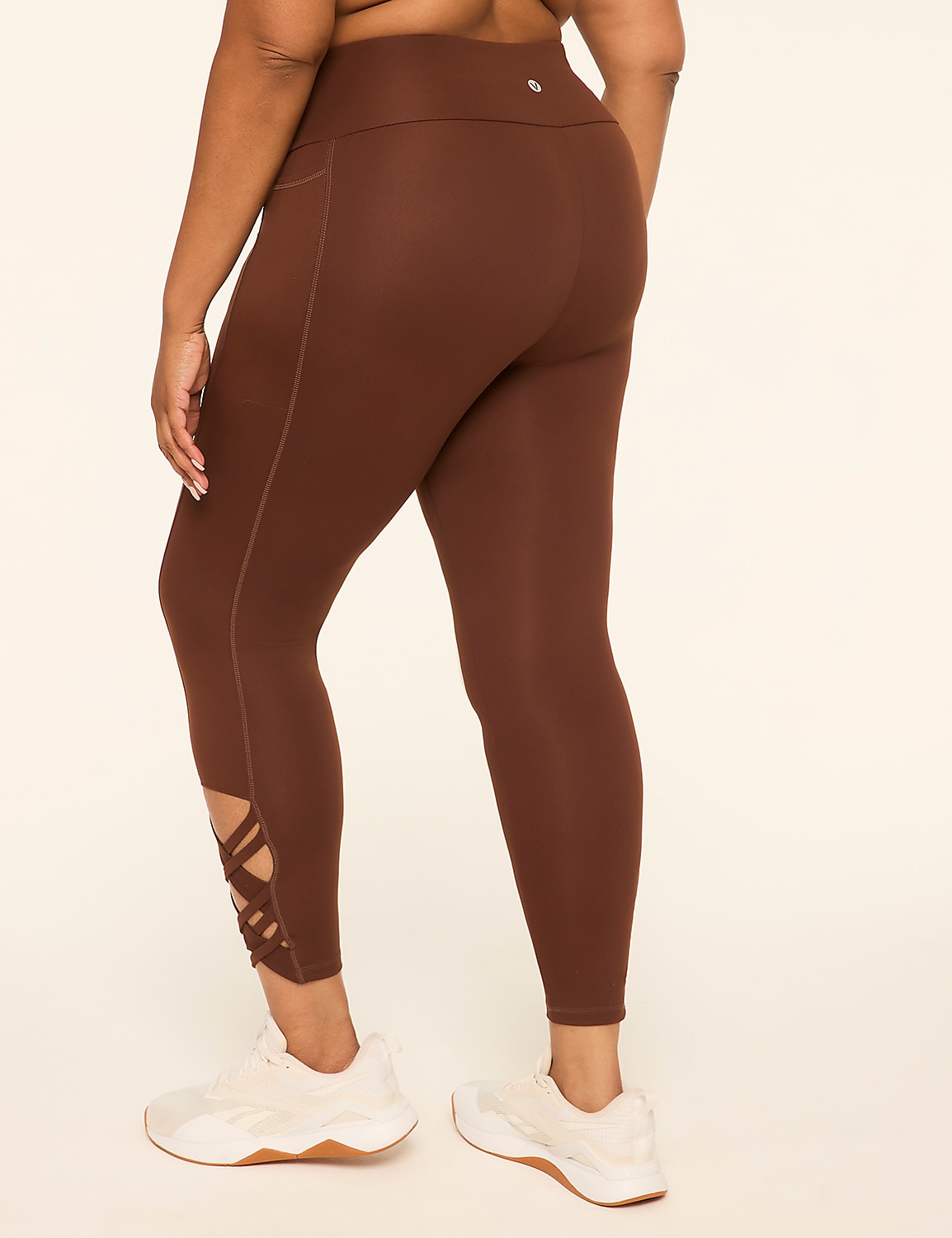 A person wearing brown leggings with a lattice detail at the ankle stands on a light-colored floor against a plain, light background. Product Image 2