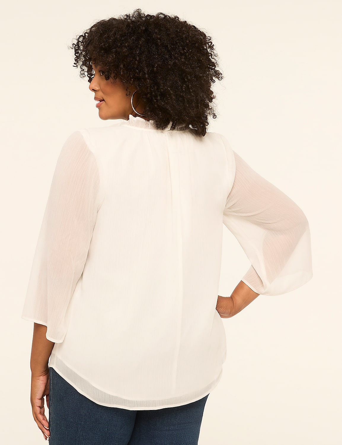 A woman in a white blouse stands against a plain, light-colored background. Product Image 2