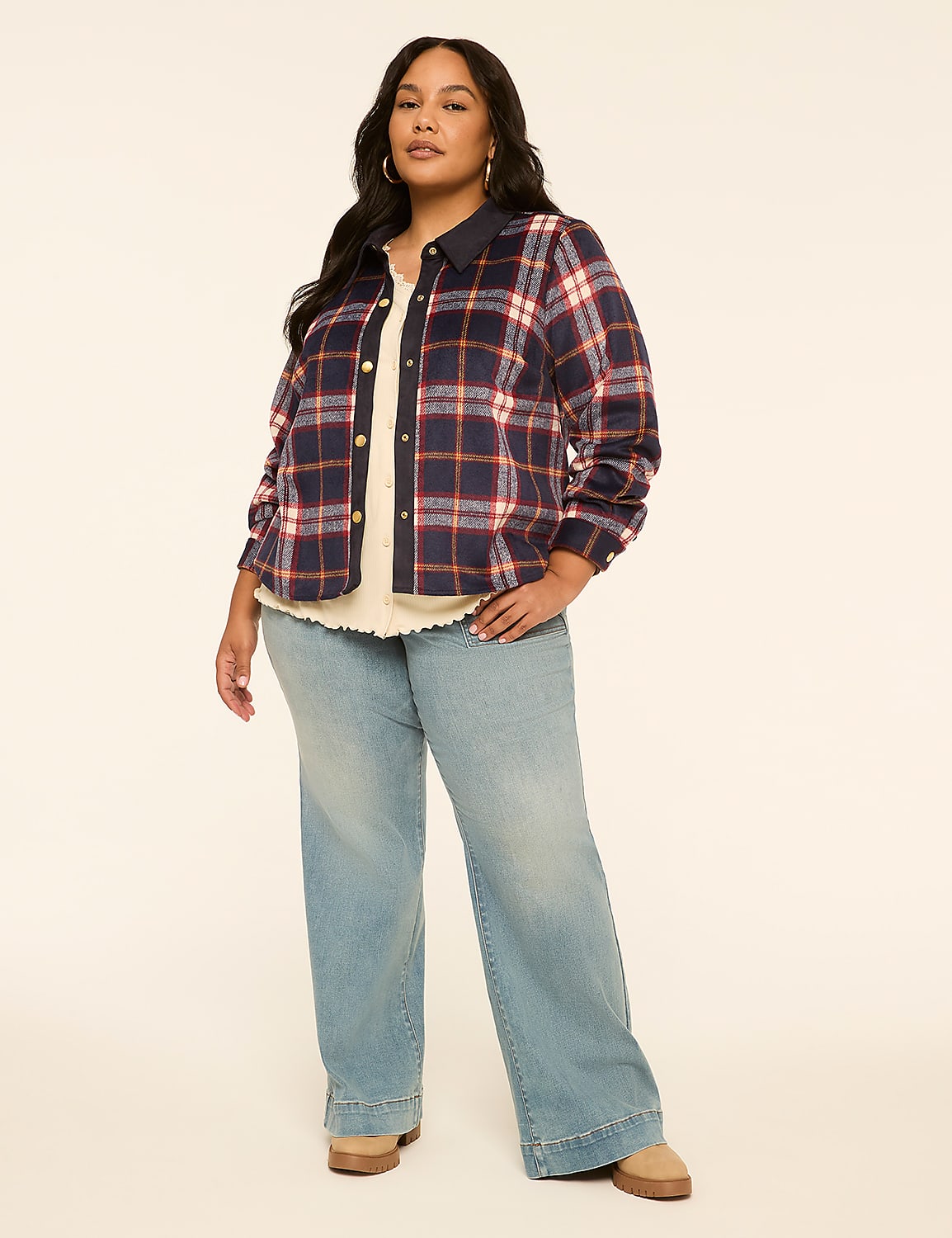 A woman in a plaid shirt and wide-leg jeans stands against a plain, light-colored background. Product Image 3