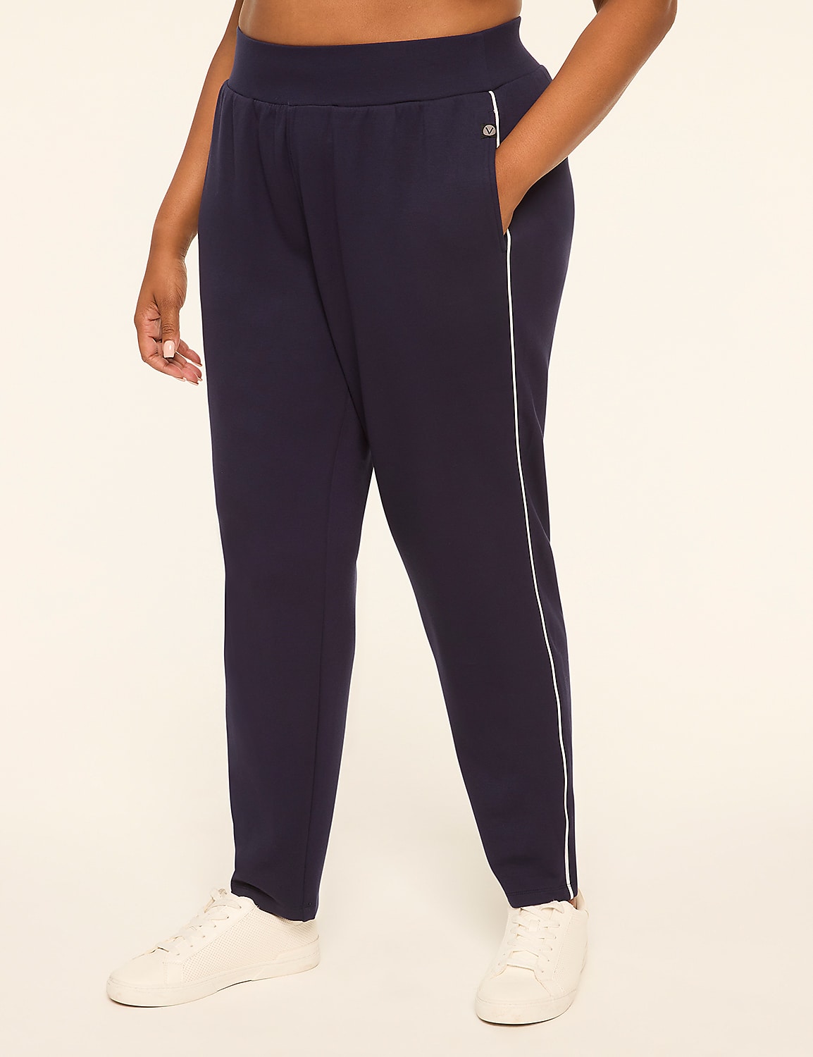 A person in navy blue sweatpants with white trim and white sneakers stands against a plain, light-colored background. Product Image 1