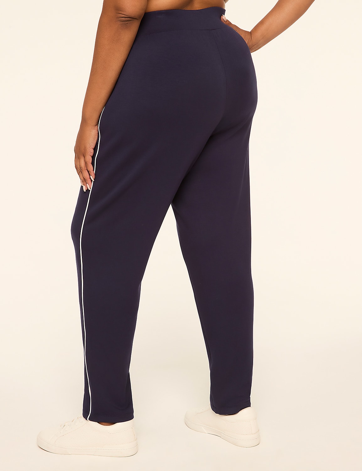 A person wearing navy blue pants with white stripes and white sneakers stands against a plain, light-colored background. Product Image 2