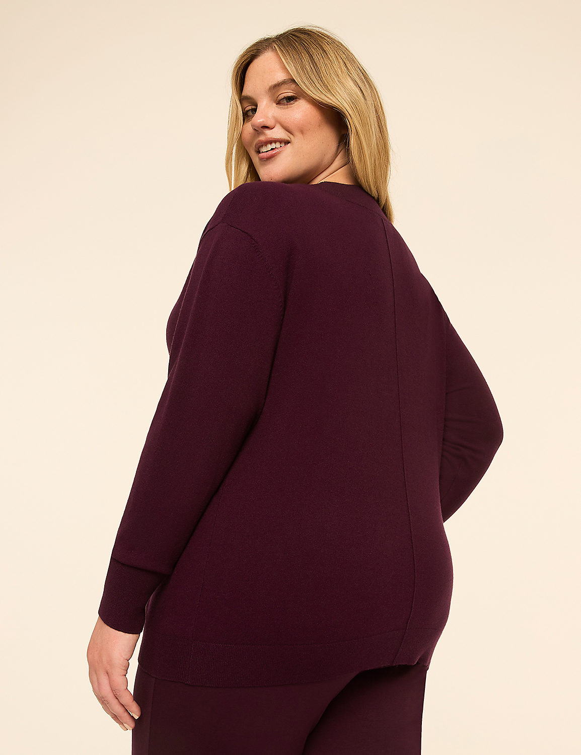 A woman in a burgundy sweater and pants stands against a plain, light-colored background. Product Image 2