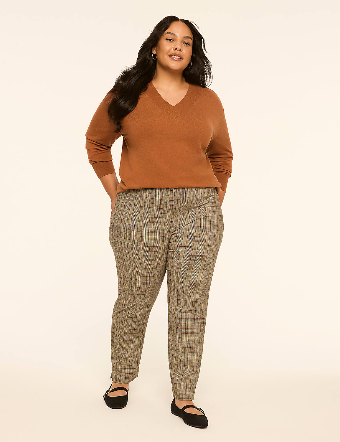 A woman in a brown v-neck sweater and plaid pants stands against a plain, light background. Product Image 3