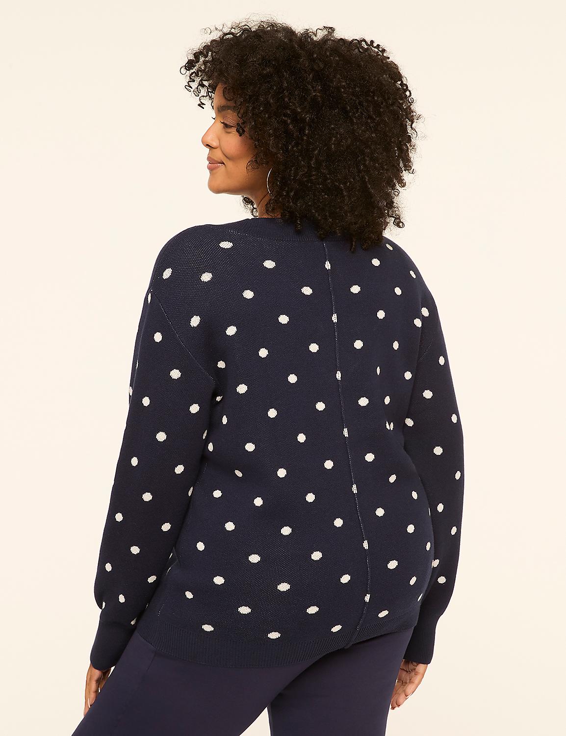 A woman in a navy polka dot sweater stands against a plain beige background. Product Image 2