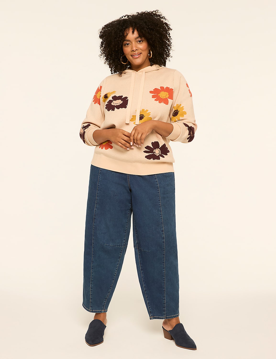 A woman in a floral hoodie and wide-leg jeans stands against a plain, light-colored background. Product Image 3