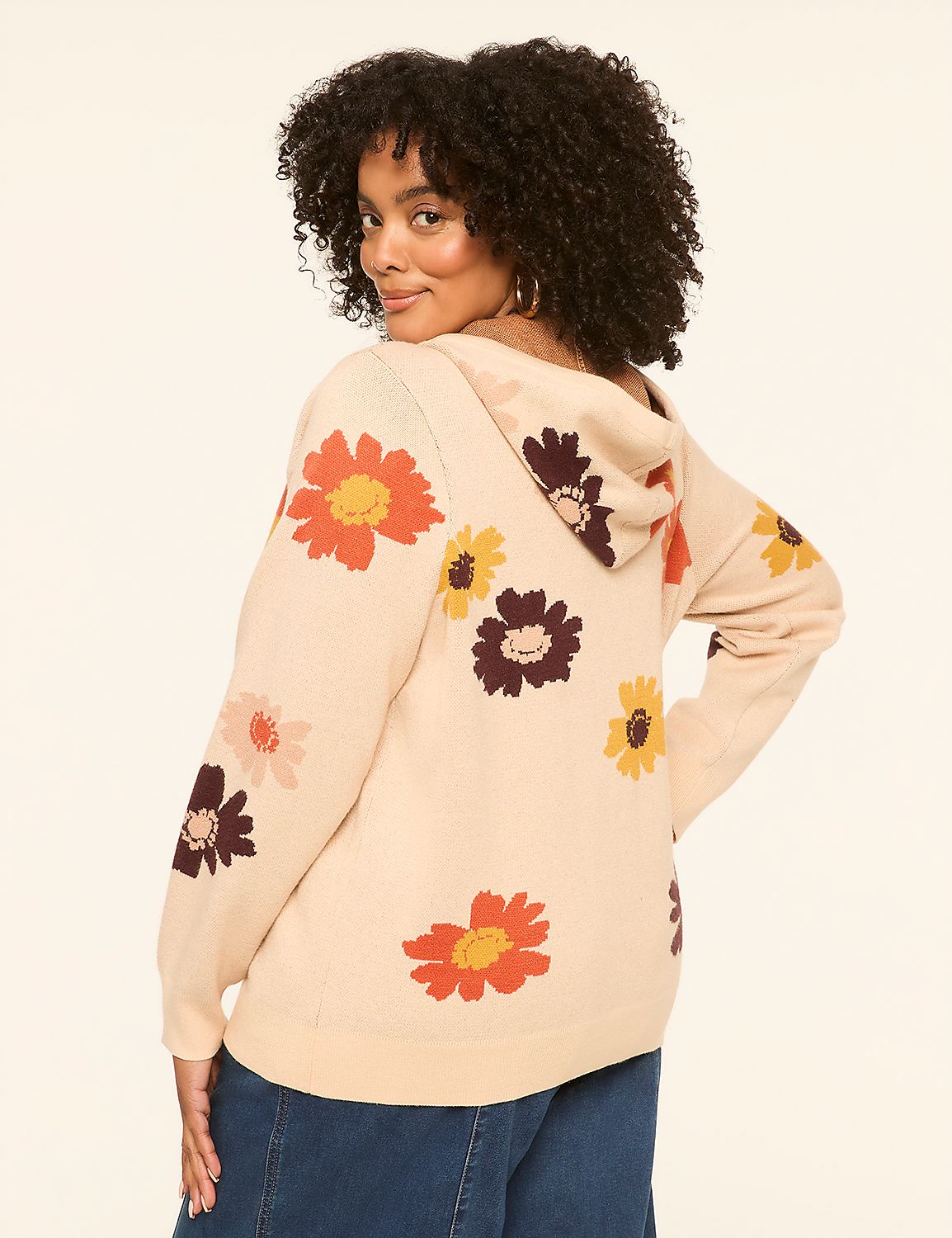 A woman in a beige floral hoodie stands against a plain, light-colored background. Product Image 2