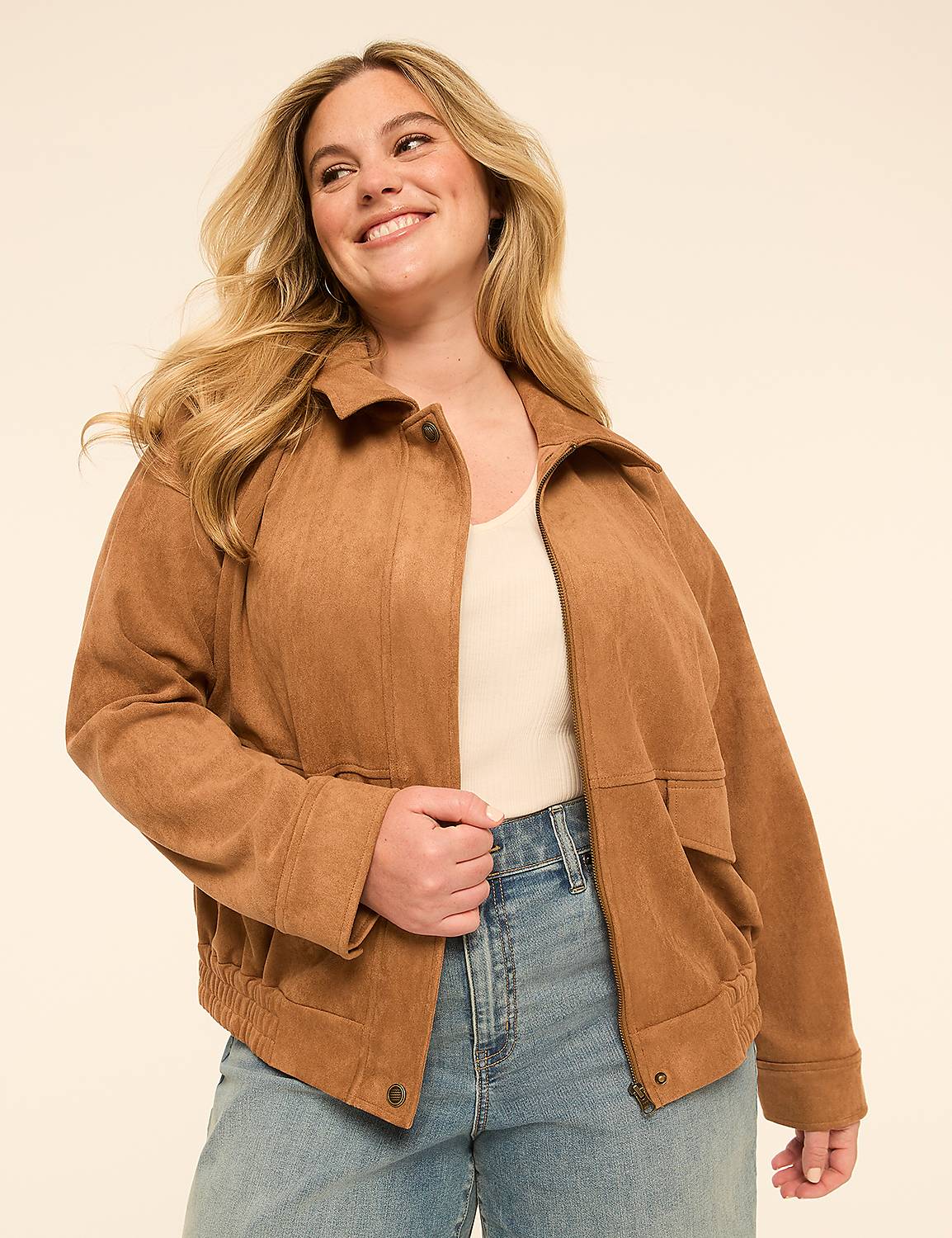 A smiling woman in a tan corduroy jacket and jeans stands against a plain, light-colored background. Product Image 1